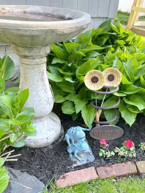 birdbath with sunflowers and rusty spring