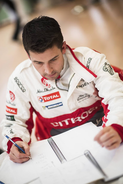 Co-driver writing his pace notes