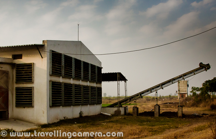 During Christmas vacations I visited Rajpura (a town in Punjab, India) with my friend, who was visiting one of his clients for some official purpose. We exactly went to a company called 'Punjab Eggs', which is one of the decent Egg producers of Punjab with main focus on nutrition. Here we are not going to share the technicalities involved, but a Photo Journey to a  Punjab Eggs Farm. Let's check it out.. It was Monday, when I was in Chadigarh and my friend called me to get ready for Rajpura, which is a relatively small town in Punjab. It took approximately 1 Hr to reach the place. We had to meet Mr. Mohit Raja, which is one of the partner in Punjab Eggs. Naresh(my friend) had official meeting with Mohit, who is also managing some other companies in Rajpura RegionPunjab Eggs is a brand of Raja Farms and one of the good quality product in North India, (as I got to know from this visit...) There are different types of eggs distributed by Peggs, depending upon the nutrition value. Different packing are used after automatic identification of different types of eggs.Cleanness and discipline is one of the main demand of such poltery farms. Cars are not allowed to come inside the campus. In worst case, if any vehicle need to come inside this huge farm, there is a track full of water, so that tyres and lower part of the vehicle is cleaned before it actually enters that campus. If someone comes inside, some solution is sprayed on shoes.Above photograph shows the preparations one need to do, before entering into the space where hens are kept under controlled temperature. A mask, cap & shoe cover etc.Here is the first view after entering into the poultry farm and this whole setup was constructed in consultation with an Europian company. Things like, space (width, height, length), Air conditioning systems, alignment of exhaust fan, unit for automatically collection eggs, cleanness of  each compartment, machines for providing feeds etc were designed in such a way that everything can be controlled through single unit on one of the corners of this poultry farmThere were different alleys with 4 storey units on both side. Each alley had hens of different types. There were two containers in front of each row - One for providing feed and other for collecting Eggs. Eggs were automatically collected at a central place, where each of them is weighted and packed accordinglyHere is a external view of Punjab Eggs unit of Raja Farms Co @ Rajpura, Punjab, IndiaMany folks prefer yellow-cover eggs and some sections of this poultry farm were having hens of a particular species. As an egg hits the region you see in this photograph, egg count of the unit goes up and can be checked exact count anytime in the software installed on conputer, which is connected to the main control unitIt was lunch time when we reached the poultry farm and all of them were busy in having their regular feed. Temperature inside was unbearable for us and whole environment was dusty due to feed distribution process, which is again handled automatically. But someone needs to refill the main containerHere exactly is feed distribution unit, which keep moving between the compartments and provide appropriate amount of feed at regular intervalsHens on right side and waiting for their turn and feed-machine of their side is still on other end of the hallExhaust fan installed on back-side of the poultry farm. each unit can be controlled separately and used  to make sure that their is proper air ventilation, along with appropriate temperature inside the poultry farMan standing in other room, where all eggs come through a rolling path. At the end of this moving path, there was a controller to weight each egg and move into appropriate sections. After this all eggs are collected and packed accordingly. There is a particular type of egg, which is marked for 'Peggs' logo...A photograph of warehouse, where some of the egg containers were lying around a corner.All special types of eggs are packed in this kind of packs with proper marking on theOthers are served in standard treys.To summarize this PHOTO JOURNEY - A Visit to fully automated Poultry Farm with Naresh and Mohit Raja. Punjab Eggs at Rajpura, Punjab, India takes care of hygiene and nutrition in their products. Overall it was a great experience to see this kind of setups in India.