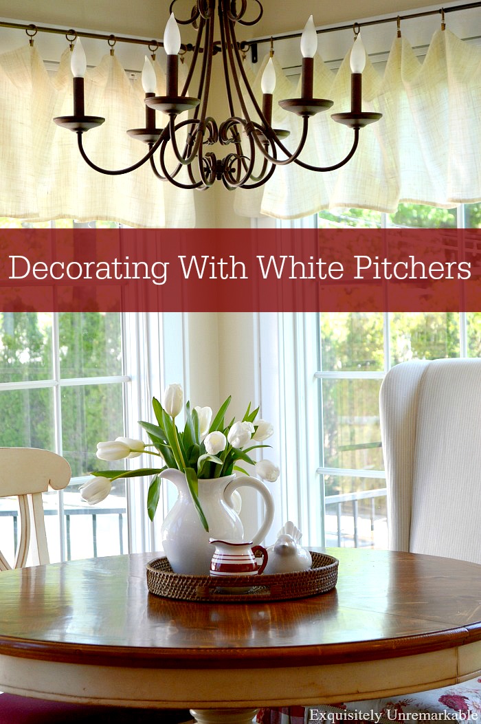 Decorating With White Pitchers text over tulip filled white pitcher on table
