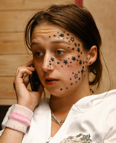 stars tattoo on her face.