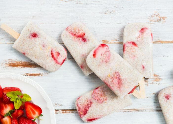 How to make strawberry chia seed popsicles recipe. This clean eating ice pops are made with strawberries and coconut milk or almond milk. They are low calorie with honey or maple syrup.  Make these healthy popsicle for kids this summer.  Simple homemade sugar free berry chia seed pops. Healthy recipes with fruit.  Diy vegan and easy chia seed recipe. #strawberry #chiaseed
