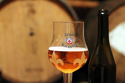 Hoppy Golden Solera with barrels in the background.