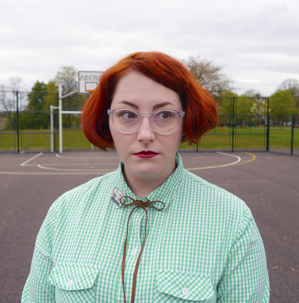 Helen as Pedro from Napoleon Dynamite Unlikely Style Icon, blog birthday, Wardrobe Conversations, Scottish bloggers, Scottish fashoin bloggers, Dundee bloggers, Pedro Sanchez, Vote for Pedro, Napoleon Dynamite style, Napoleon Dynamite costume, easy costume idea, film costume, movies costume idea, charity shop find, checked shirt, green gingham shirt, little lies boho necklace, cassestte brooch, cowgirl style, western style, simple wild west outfit, new look jeans, zara brown boots, bad hair day, #seewithiolla, iolla glasses, Iolla clear Bell frames