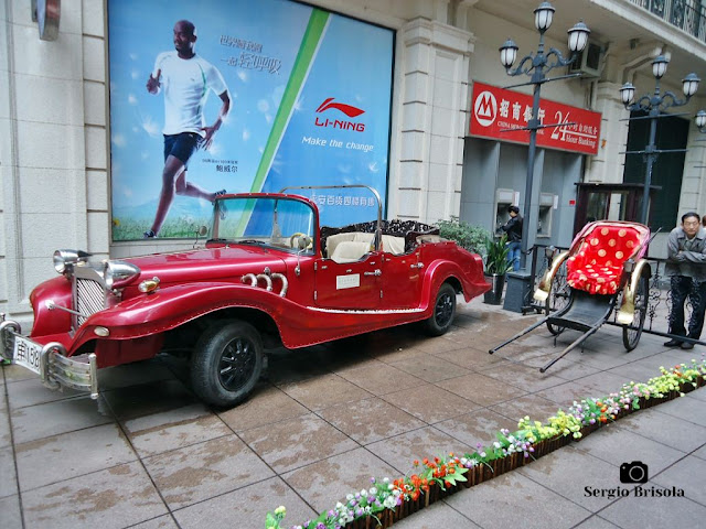 Old time car and rickshaw (pedicab) exposed at Nanjing Road in Shanghai Old time car and rickshaw (pedicab) exposed at Nanjing Road in Shanghai
