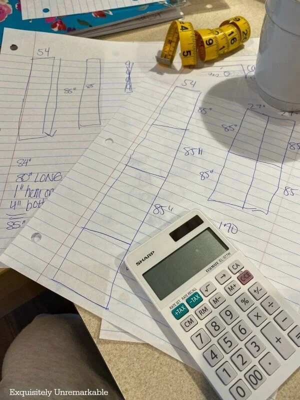 Looseleaf paper with curtain pattern drawings on desk with calculator and measuring tape