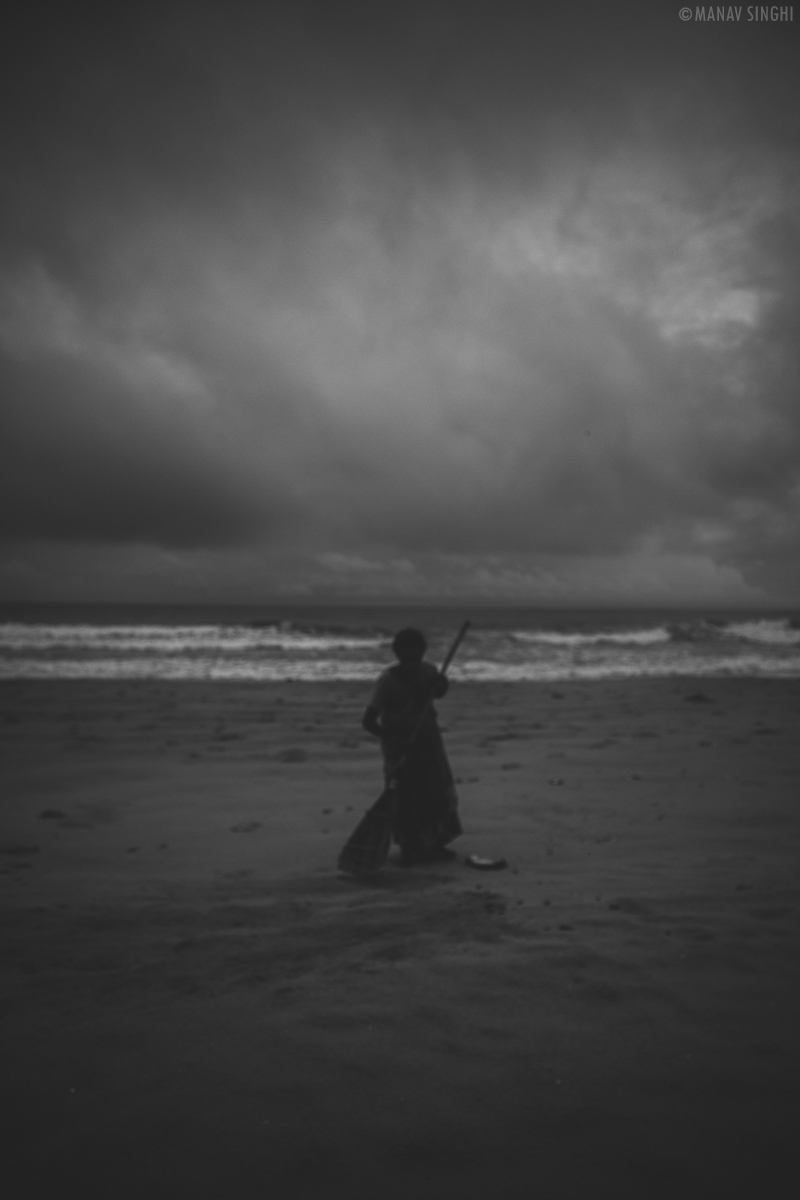 A lady staff of Le Pondy Beach Resort cleaning the Beach in front of it's property- 30-Oct-2019