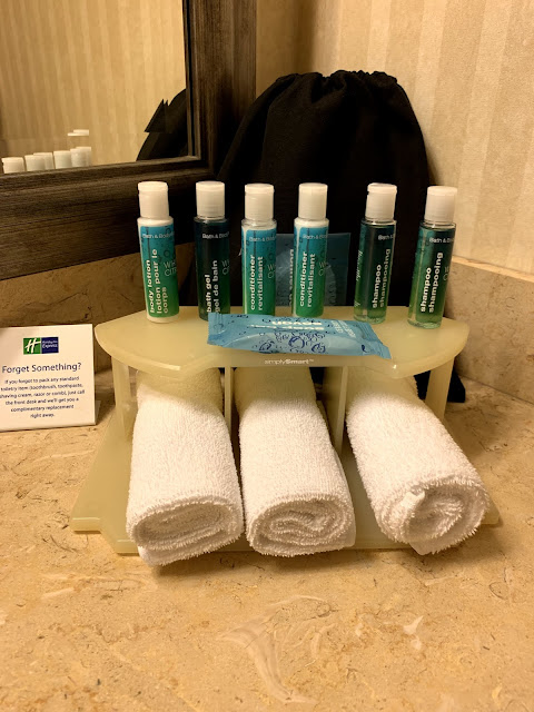 a group of toiletries and towels on a counter