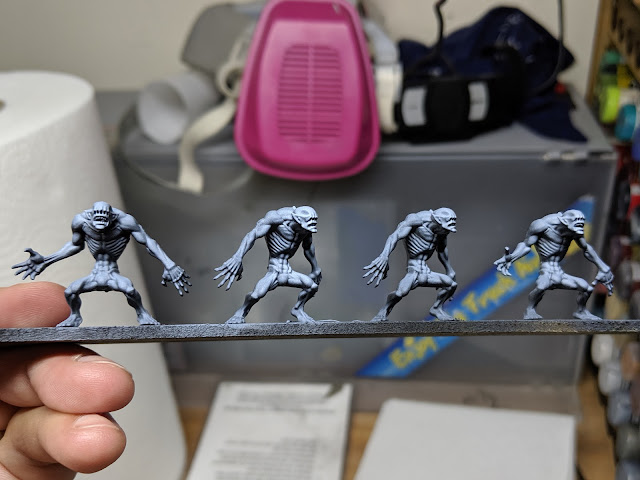 4 little monsters stood in a row First pass with the wash