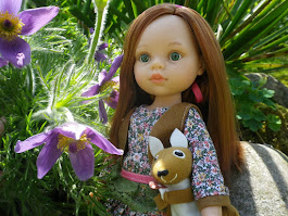 Amalie sitting by some purple flowers.