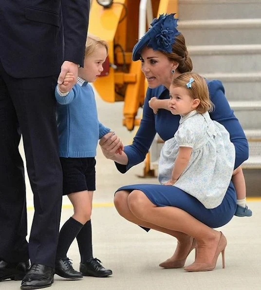 Duchess Catherine wore a bespoke blue dress by designer Jenny Packham. Gianvito Rossi 105 Suede Pumps. L.K. Bennett Nina Clutch.