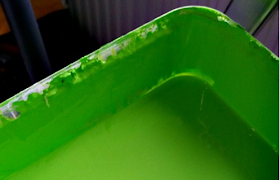 A tub of bright green paint