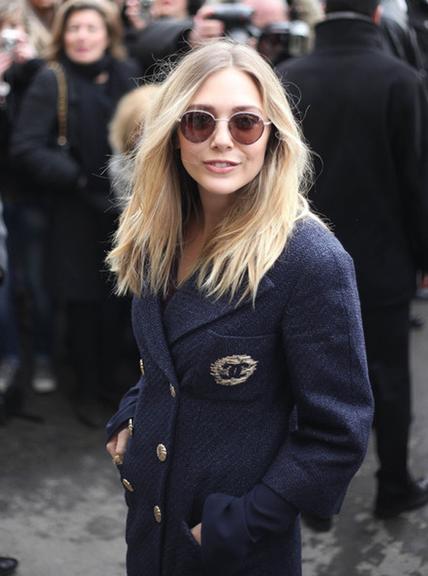 Elizabeth Olsen is Sissy Spacekesque in round tinted sunglasses paired with 