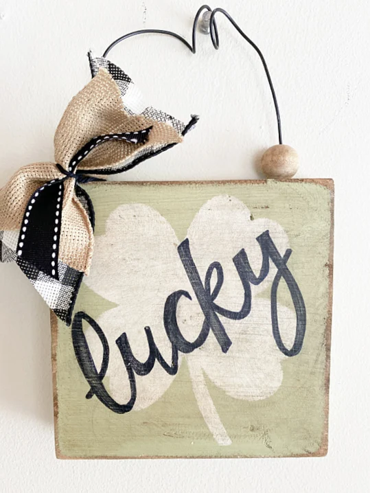 cursive lucky sign with bow and wire hanger