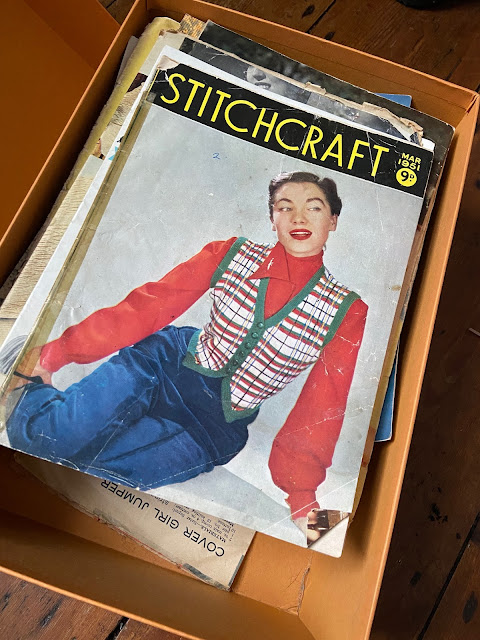 A box of old knitting patterns.