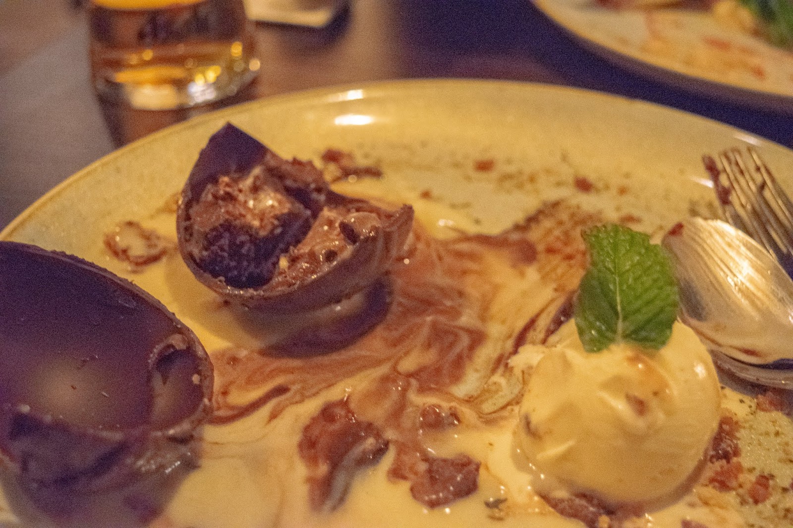 What Cat Says | Country Pub & Dining Experience at The Red Lion, Welwyn A broken chocolate sphere showing a chocolate and hazelnut mousse inside.