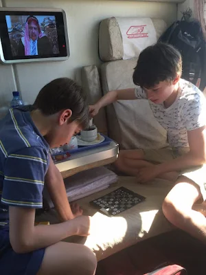 Children playing checkers in the train 