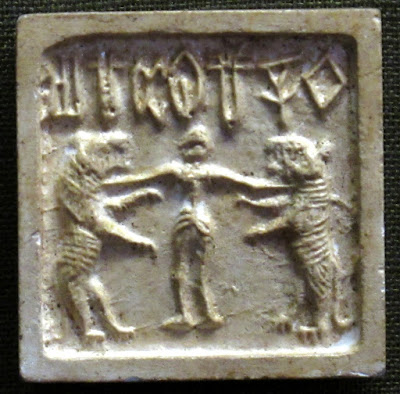 Mohenjo-Daro seal depicting a man between two tigers.