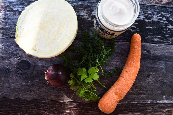 Ingredients to make carrot coleslaw Ingredients to make carrot coleslaw - white cabbage, carrot, dill, parsley & mayo