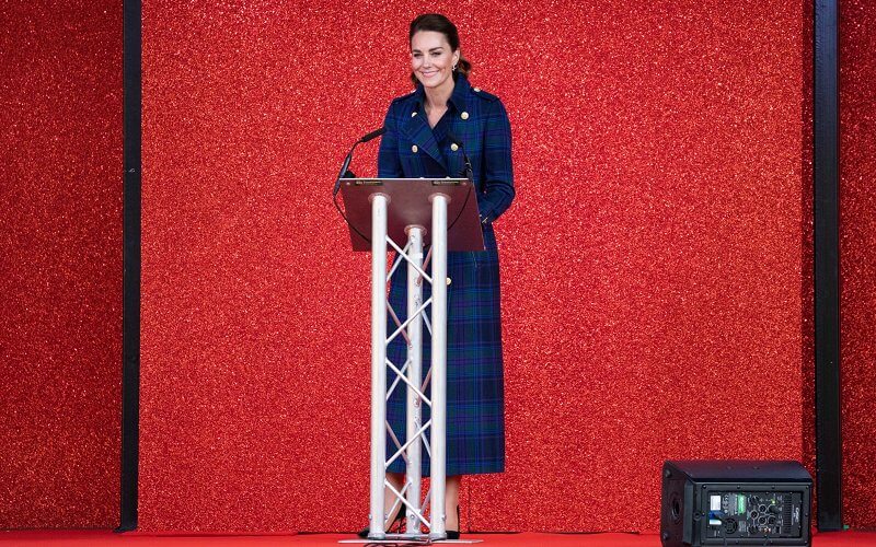 Kate Middleton wore a full length marlborough heather tartan trench coat  from Holland Cooper. Joseph metallic knitted skirt