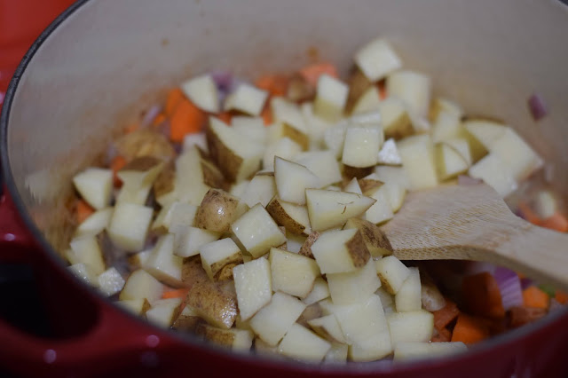 The diced potatoes being added to the pot.