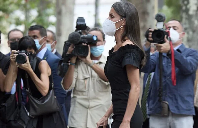 Queen Letizia wore a new Lolita black midi dress by Maria Malo. Sustainable dress. Carolina Herrera suede black pumps