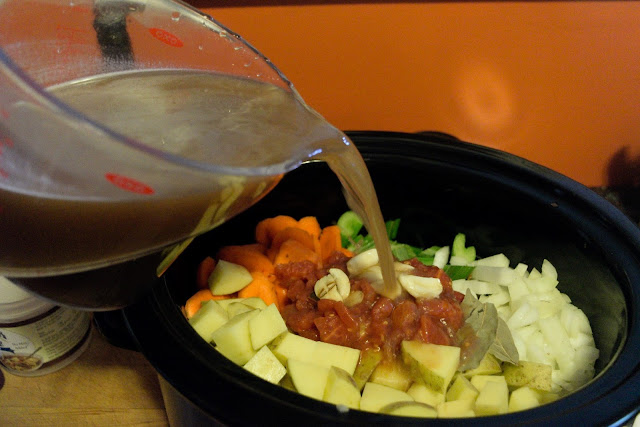 Beef stock being added to the slow cooker. 