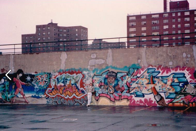 Man standing in front of graffiti 