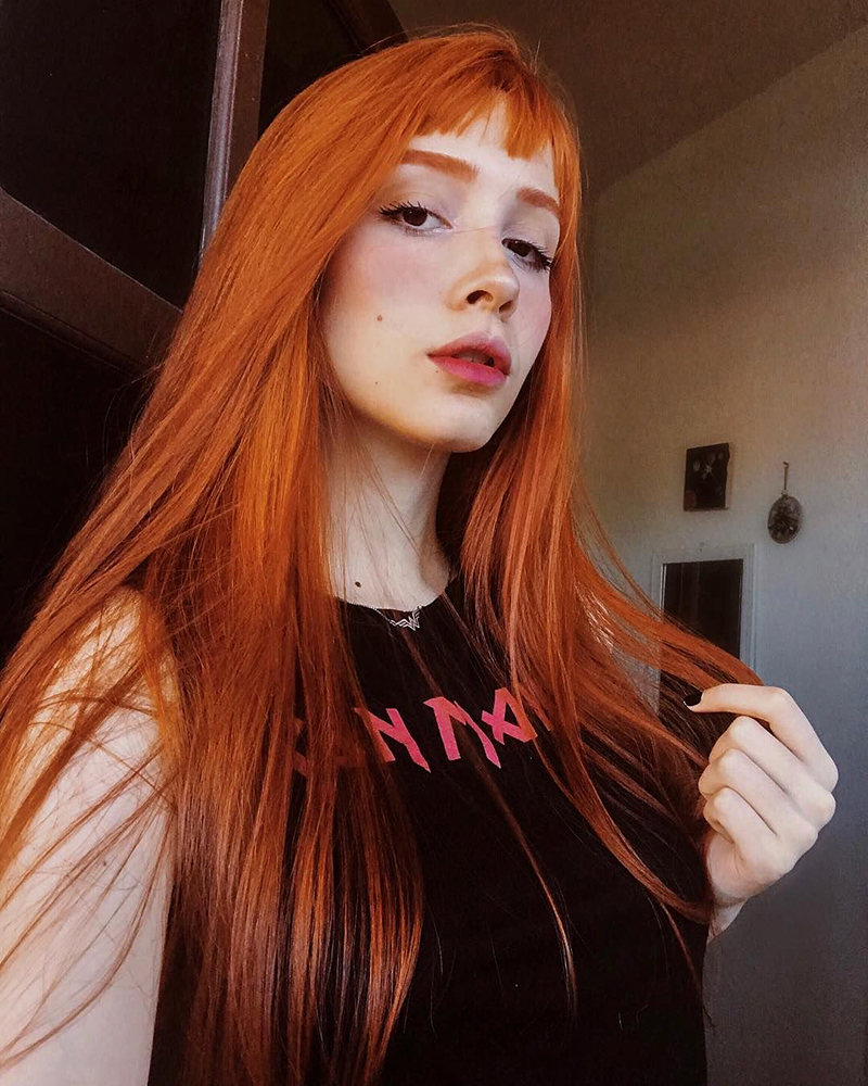beautiful woman with a Pumpkin Spice Hair Color and long hairstyle