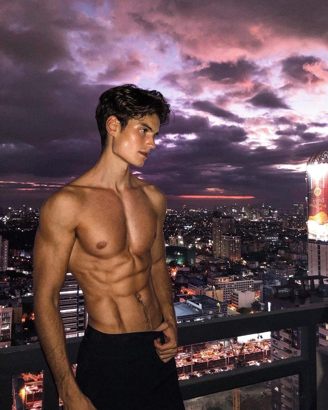 cute-shirtless-fit-male-model-twink-abs-jawline-rooftop-city-view