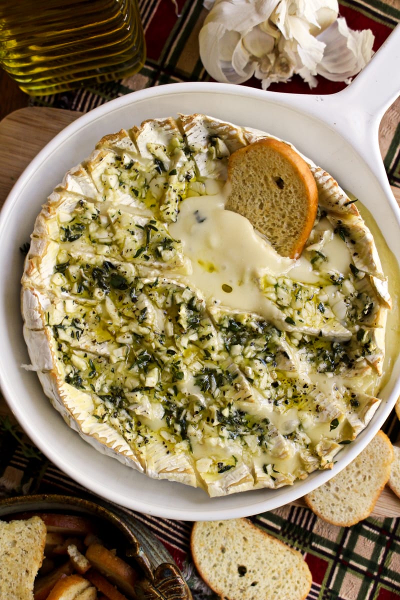 Garlic and Herb Baked Brie | The Two Bite Club | #brie #appetizerrecipes Garlic and Herb Baked Brie topped with garlic, herbs, and olive oil.
