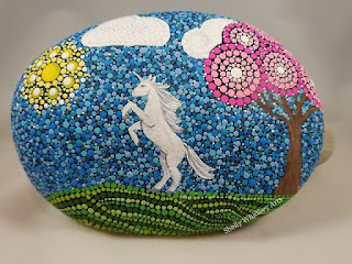 dot art background with unicorn on painted rock dot painting rock art ideas