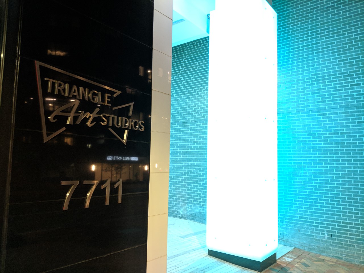 Robert Dyer Bethesda Row Sign lit at Triangle Art Studios