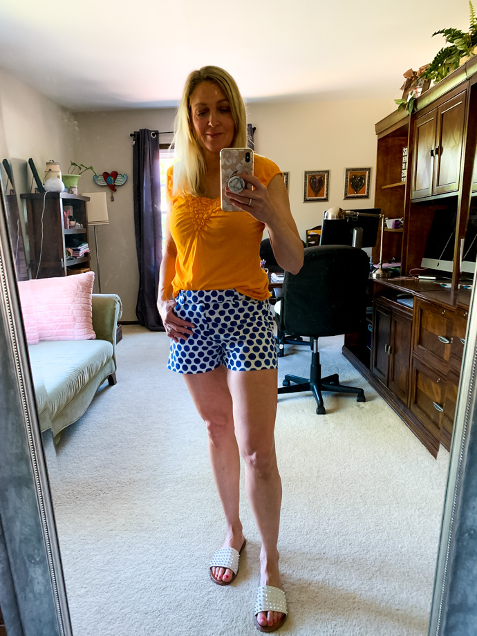 orange top and navy polka dot shorts