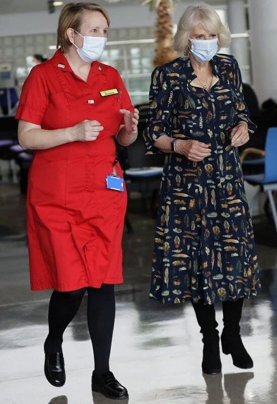 The Duchess of Cornwall wore a navy blue shirt dress with feather print detail