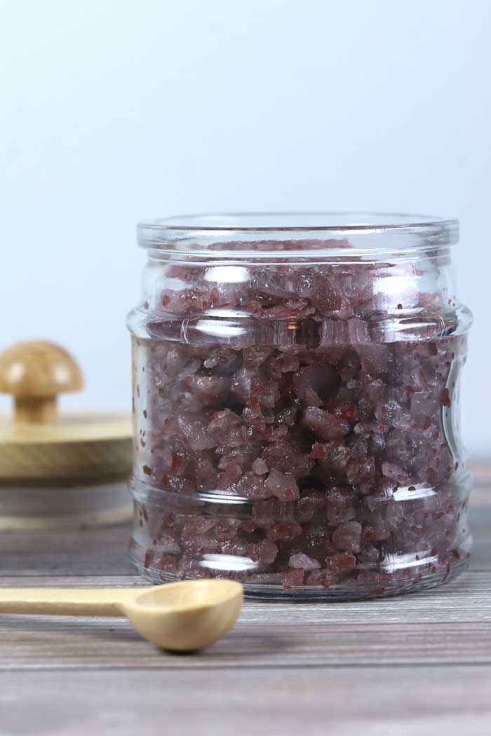These DIY bath salts are relaxing and help promote better sleep with essenital oils and magnesium flakes. How to make easy bath salts with benefits like helping you relax and stress relief. This homemade recipe makes a great gift.  It uses oils that are safe for kids too. It has lavender, cedarwood, vetiver, blue tansy, and chamomile for natural things to help you sleep. How to use home made bath salts to promote better sleep. #bathsalts