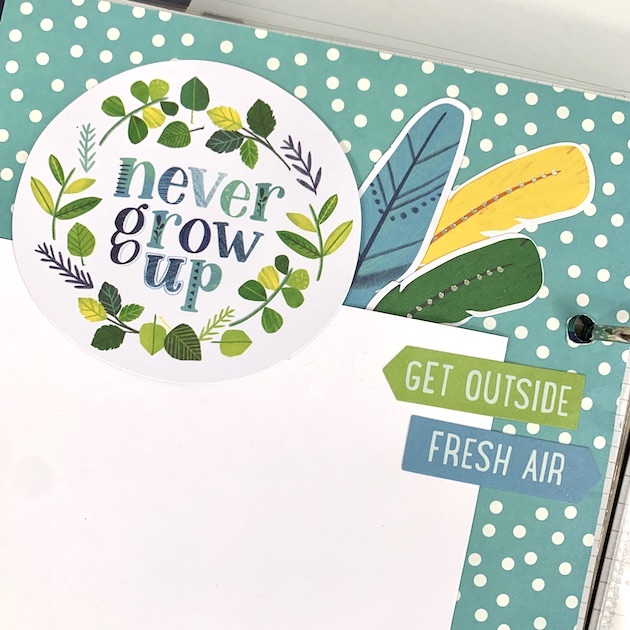 Never Grow Up scrapbook album page with nature theme and feathers