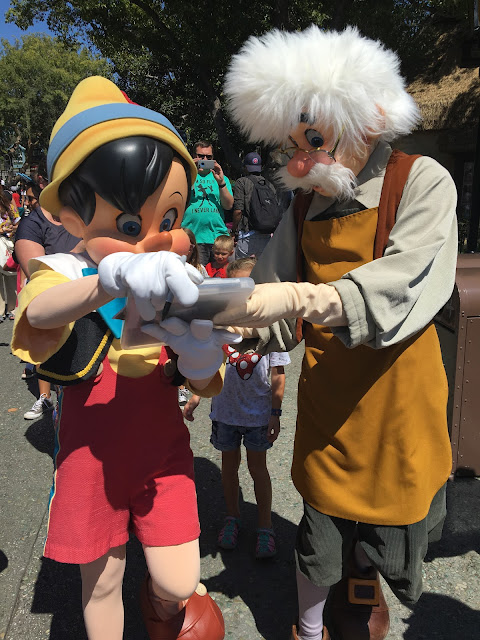 Pinocchio and Geppetto Signing Autographs in Fantasyland Disneyland