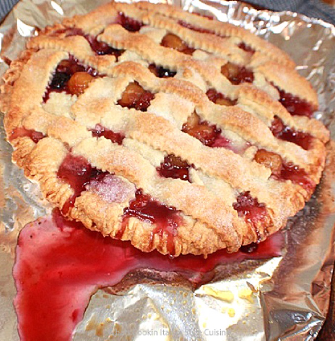 Butter Crust Deep Dish Peach or Cherry Berry Cobbler this is a berry cherry pie baking on foil