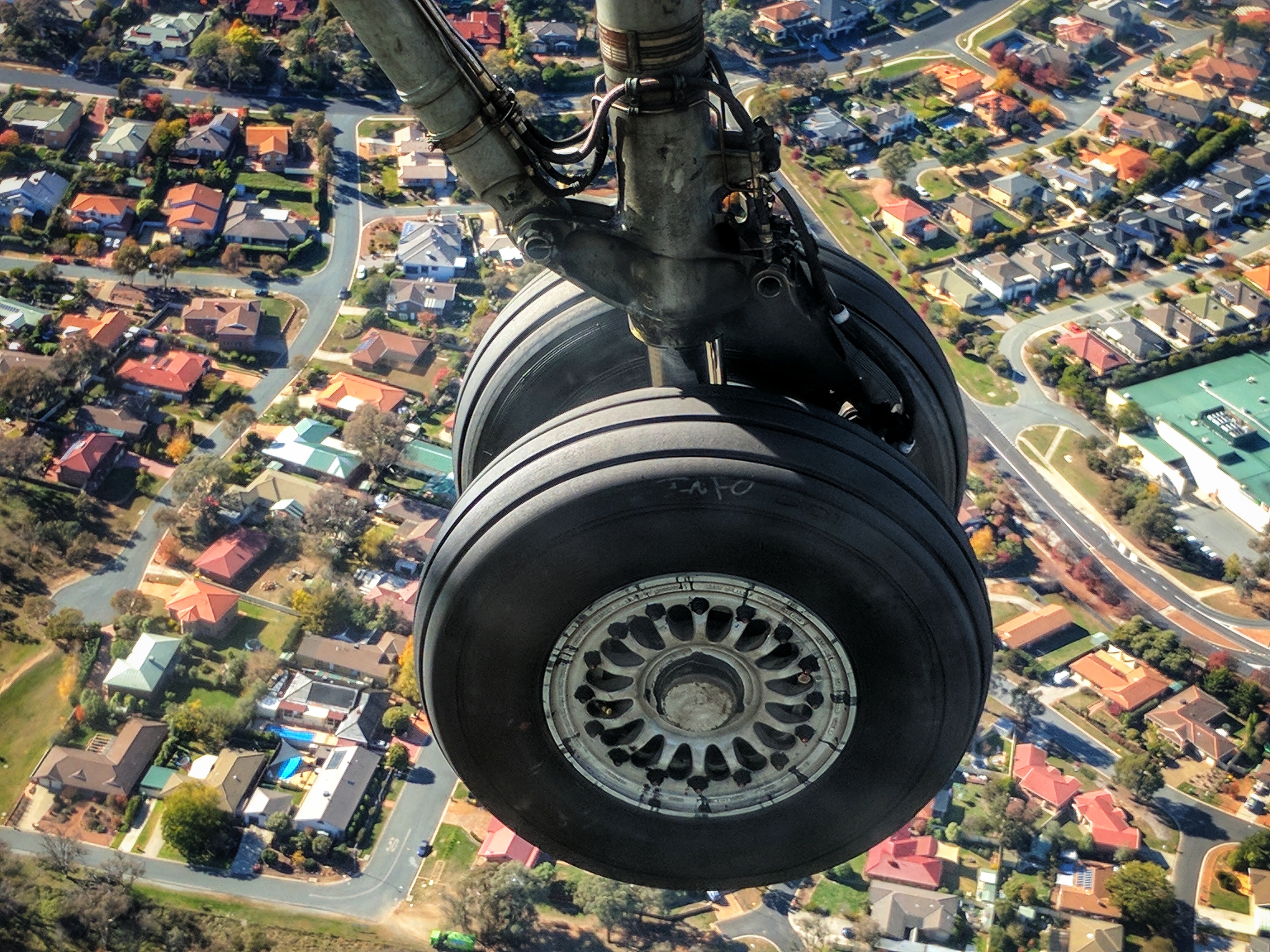 Airplane wheel down for landing over Camberra