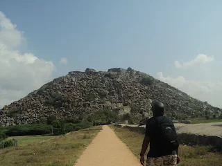 Hiker watches the mighty Gingee fort stand in all her glory