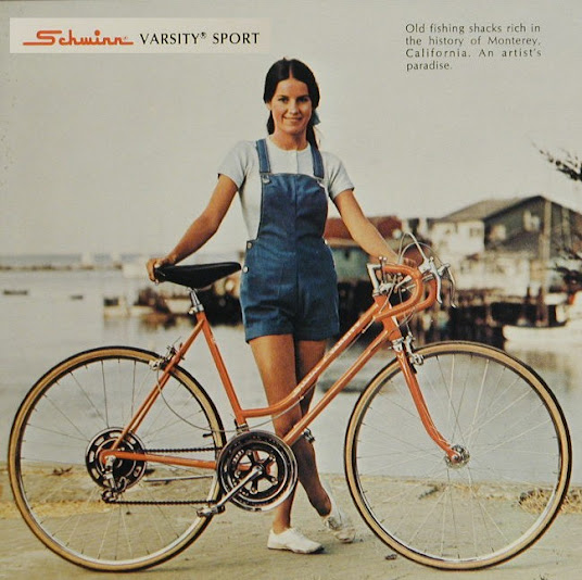 Woman in front of vintage bicycle