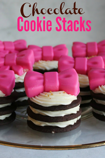 It is always fun to have a cookie cut in a pretty shaped and decorated with frosting, but you aren't limited to sugar cookies. There are lots of flavors and types of cookies you can roll and cut, here are a few of our favorite recipes. stacks of dark chocolate cookies with buttercream sandwiched between them and a pink chocolate bow on top