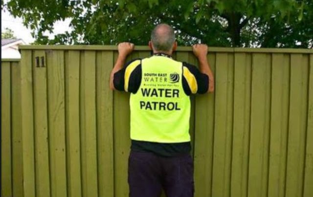 California "water cop" peeking over a fence onto private property