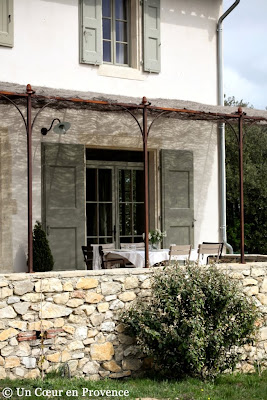 Facade with stone surrounds and pergola