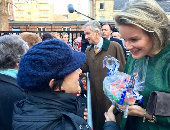 Queen Mathilde srtle, wore Dries Van Noten 3D effect coat, Natan suede clutch and Natan shoes, gold earrings