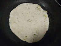 Cooking aloo paratha in a non stick pan