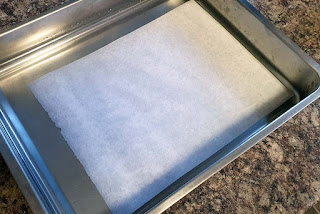 Showing paper soaking in a large tray containing 2% salt solution