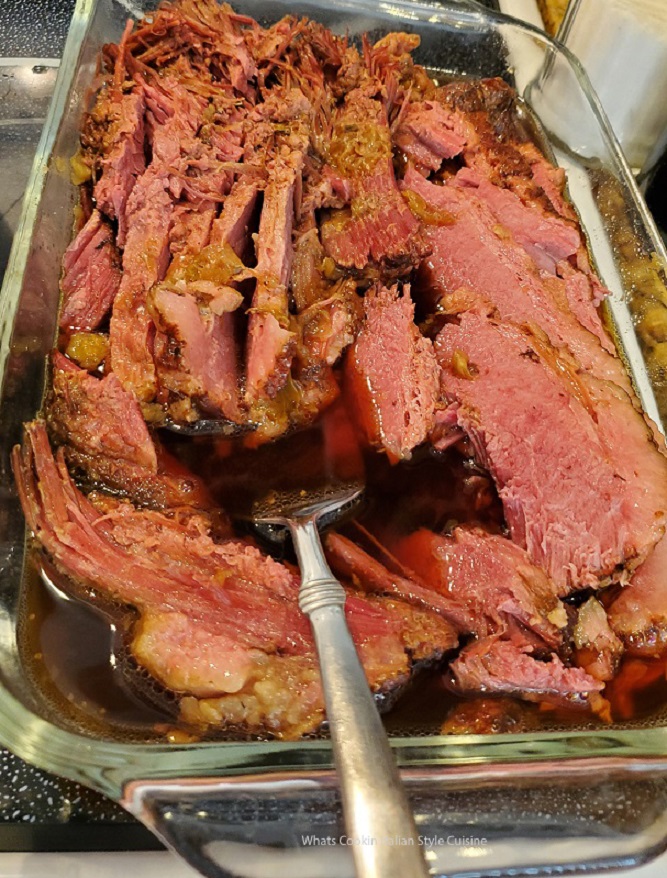 this is corned beef in guinness beer cooked in a pressure cooker or slow cooker and how to prepare it. The meat is cooked sliced and in it's juice made from the beer