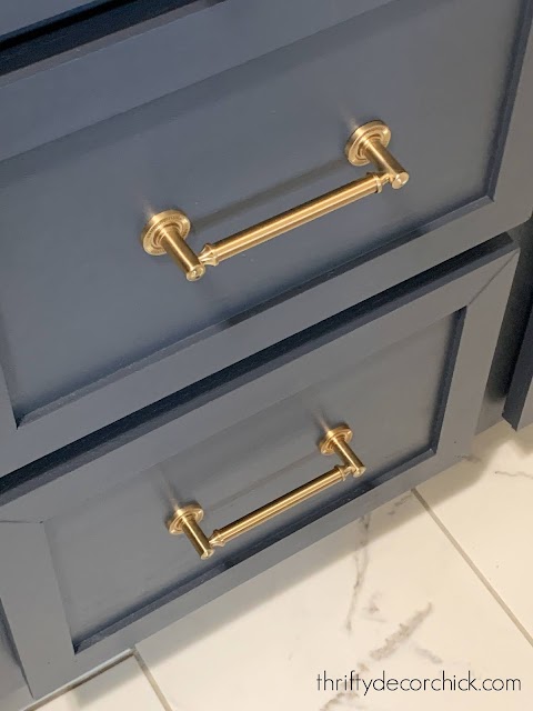 dark blue cabinets with brass hardware